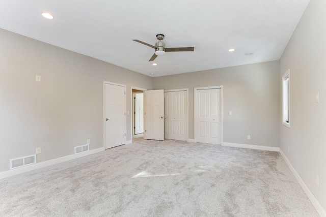 3571 Centerville Rd, Vadnais Heights, MN 55127 - unfurnished bedroom with multiple closets, baseboards, light carpet, recessed lighting, and ceiling fan