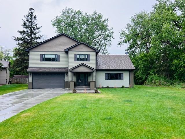 3571 Centerville Rd, Vadnais Heights, MN 55127 - split level home with an attached garage, driveway, and a front lawn