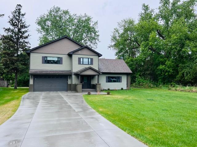 3571 Centerville Rd, Vadnais Heights, MN 55127 - view of front facade with driveway, a garage, and a front lawn