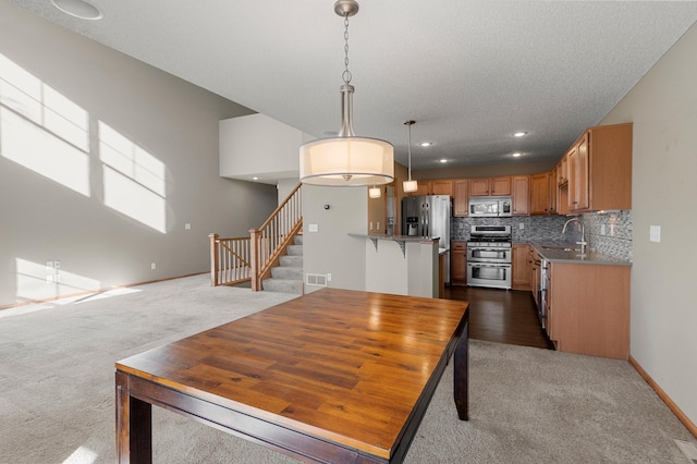 carpeted dining space featuring sink