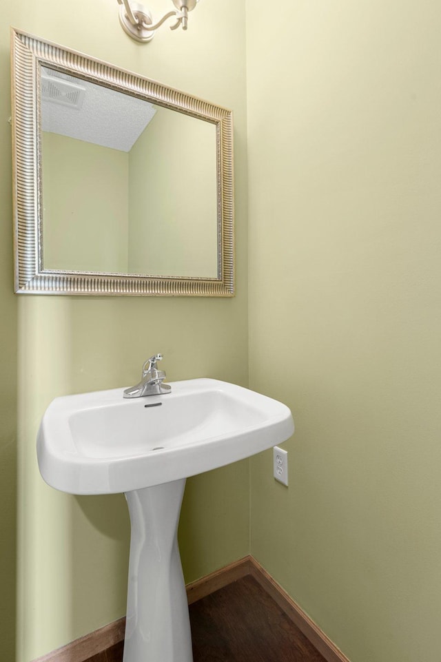 bathroom with sink and hardwood / wood-style floors