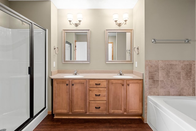 bathroom featuring vanity, hardwood / wood-style flooring, and shower with separate bathtub