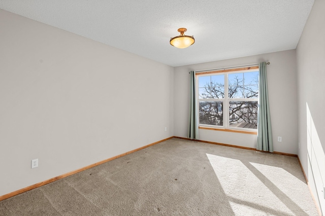 carpeted spare room featuring a textured ceiling