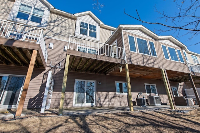 rear view of house with a patio and central AC unit