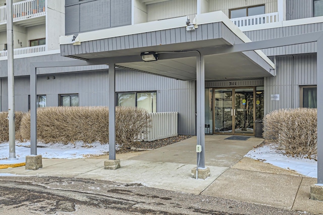 view of snow covered property entrance