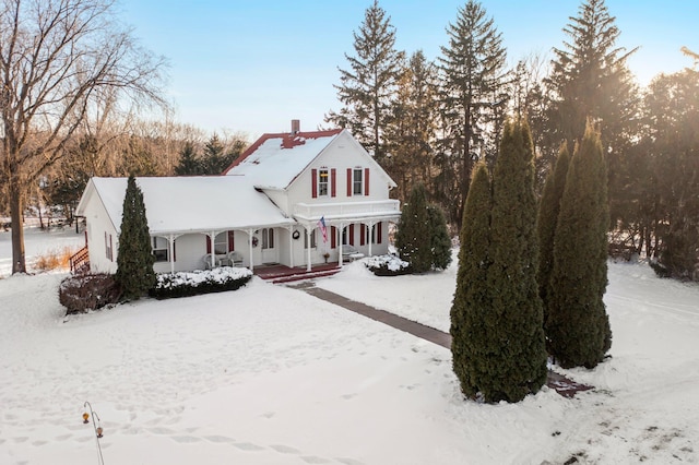 view of front of property with covered porch and a chimney