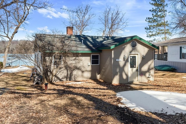 view of side of home featuring a chimney