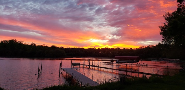 dock area with a water view and boat lift