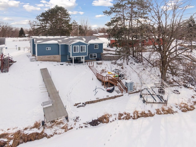 view of snow covered back of property