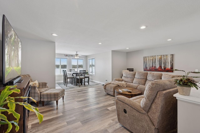 living room featuring a textured ceiling and light wood-type flooring