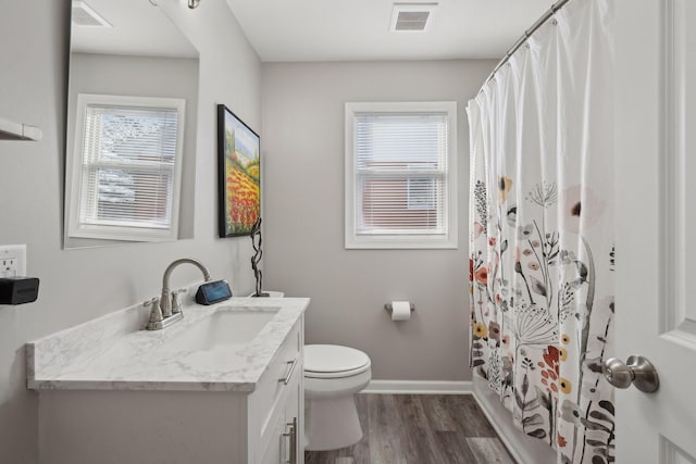 bathroom with vanity, hardwood / wood-style flooring, curtained shower, and toilet