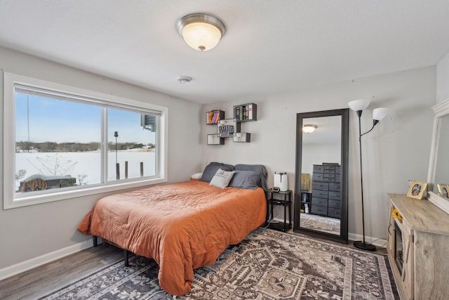 bedroom with dark wood-type flooring