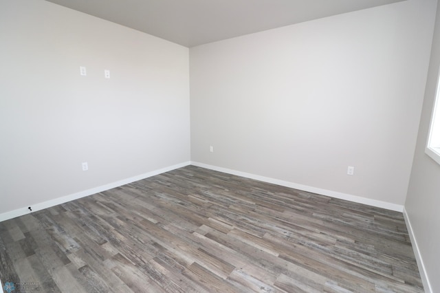 spare room with wood-type flooring