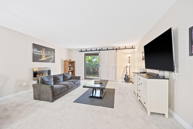 carpeted living room featuring a barn door