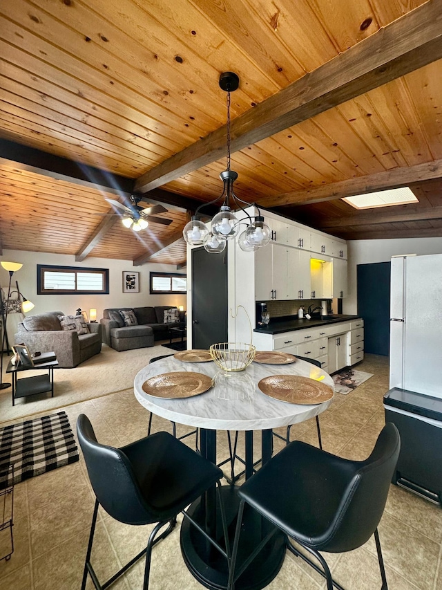 dining area featuring wood ceiling, beam ceiling, ceiling fan, and light tile patterned flooring