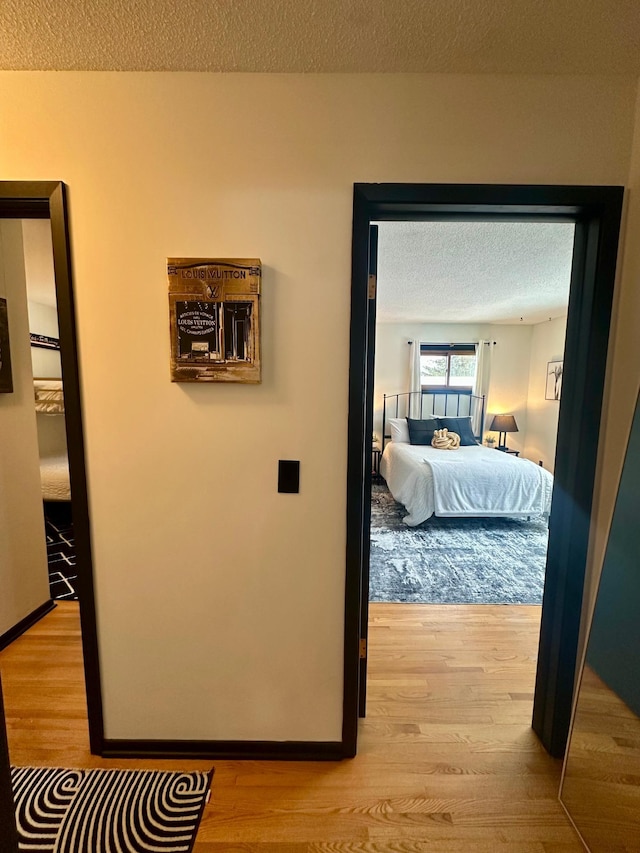 bedroom featuring hardwood / wood-style flooring and a textured ceiling