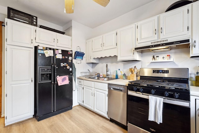 kitchen featuring stainless steel appliances, a sink, white cabinetry, and under cabinet range hood