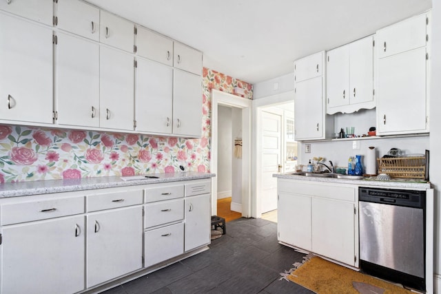 kitchen featuring open shelves, light countertops, white cabinets, a sink, and dishwasher