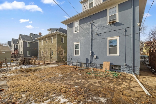 back of property with fence and stucco siding