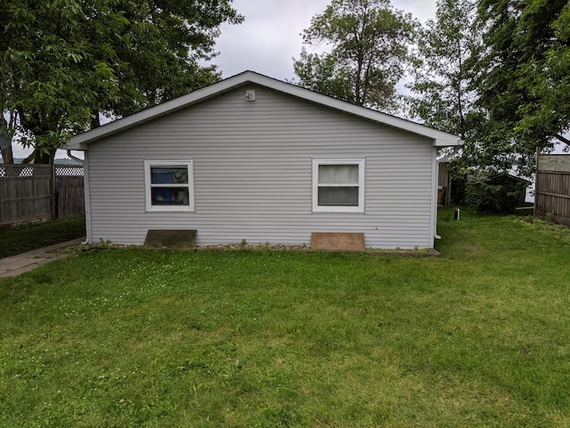 view of property exterior with a lawn