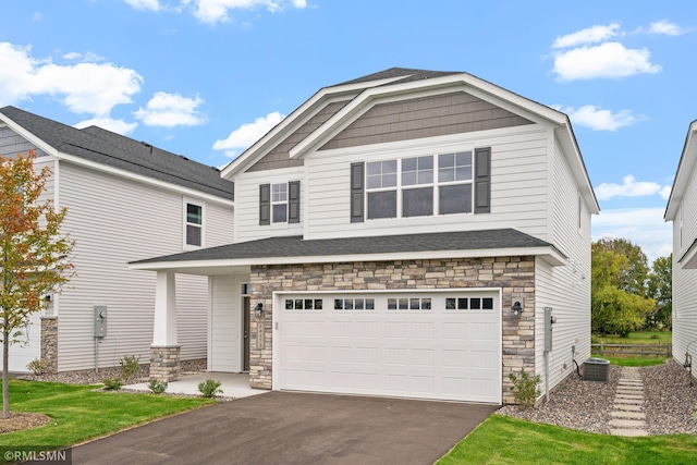 view of front of house featuring cooling unit and a garage