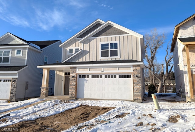 view of front of property with board and batten siding, stone siding, and a garage