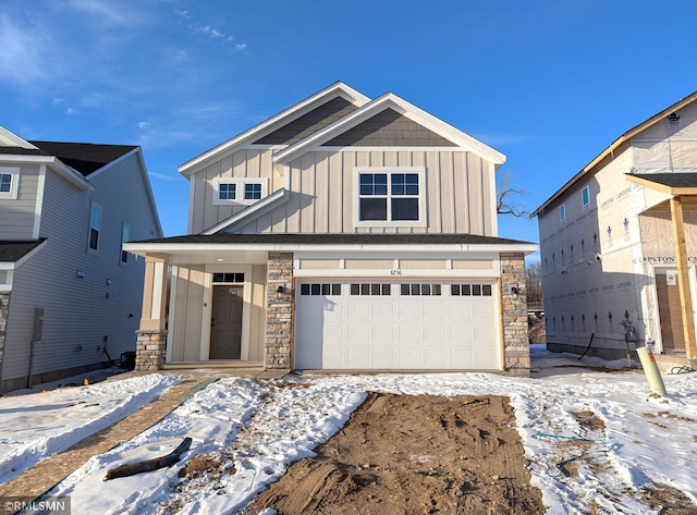 view of front of house with an attached garage, board and batten siding, and stone siding