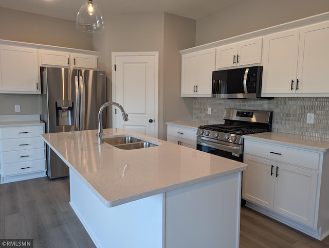 kitchen featuring a sink, decorative backsplash, appliances with stainless steel finishes, and dark wood-style floors