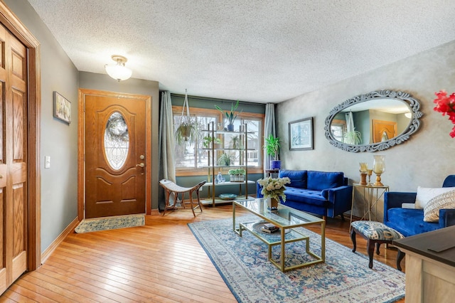 entrance foyer featuring light hardwood / wood-style flooring and a textured ceiling