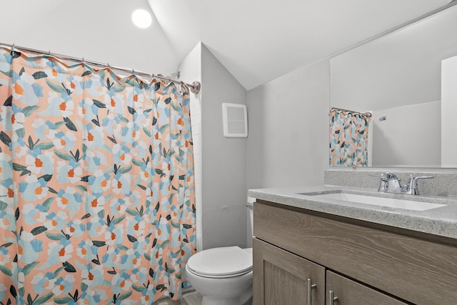 bathroom featuring toilet, a shower with curtain, vaulted ceiling, and vanity