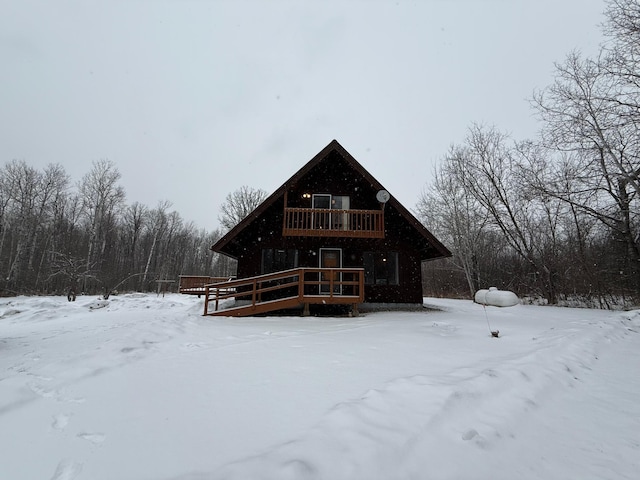 snow covered property with a wooden deck