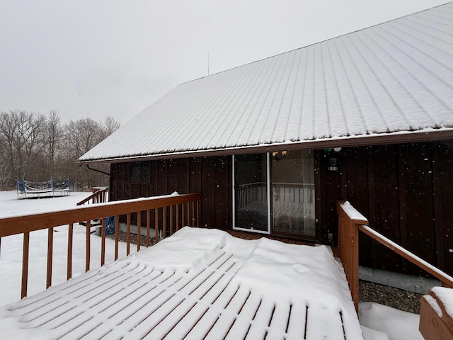 snow covered deck featuring a trampoline