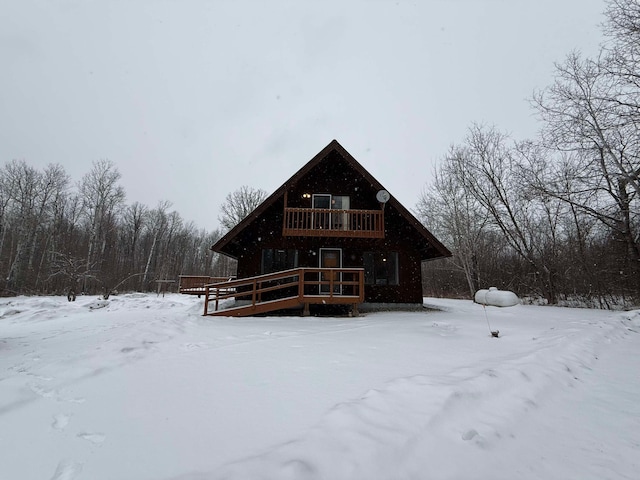 snow covered house with a deck