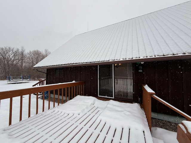 snow covered deck with a trampoline