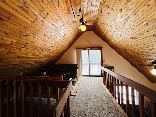 interior space with ceiling fan, carpet flooring, vaulted ceiling, and wooden ceiling