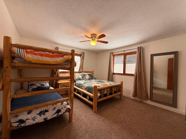 bedroom featuring carpet floors, a textured ceiling, and ceiling fan