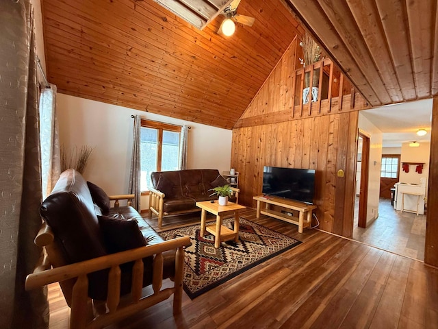 living room with hardwood / wood-style flooring, wooden walls, wooden ceiling, and high vaulted ceiling