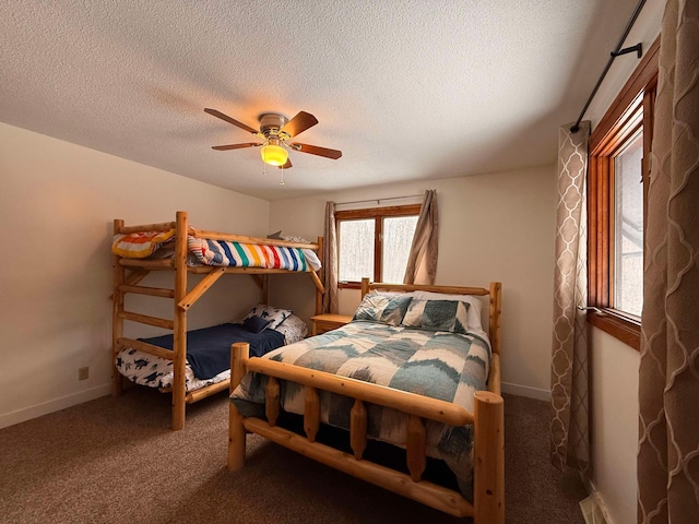 carpeted bedroom with a textured ceiling and ceiling fan