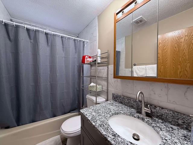 full bathroom featuring toilet, a textured ceiling, tile walls, vanity, and shower / bath combination with curtain