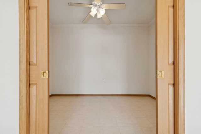 empty room featuring ornamental molding, baseboards, and a ceiling fan