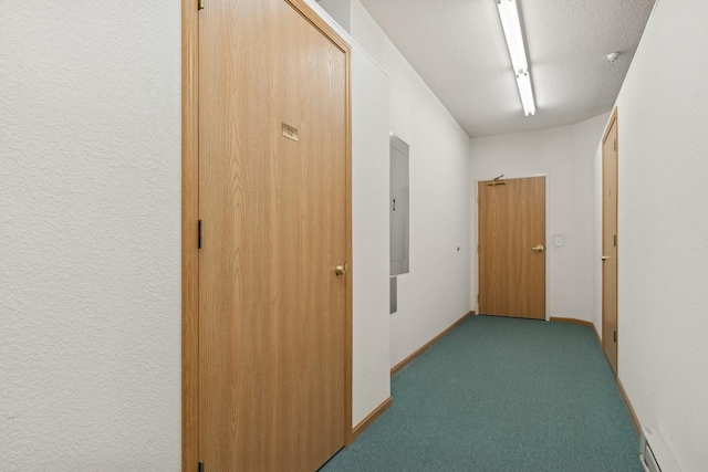 corridor with electric panel, light carpet, a textured ceiling, and baseboards