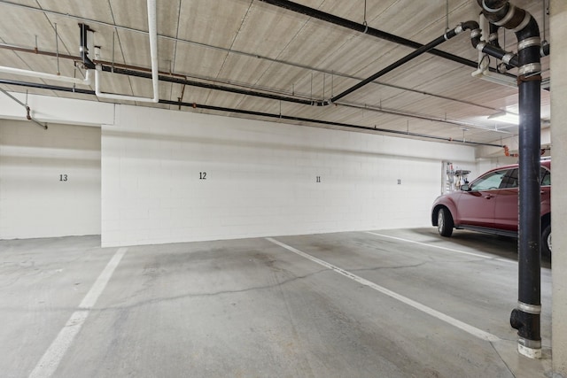 parking garage featuring concrete block wall