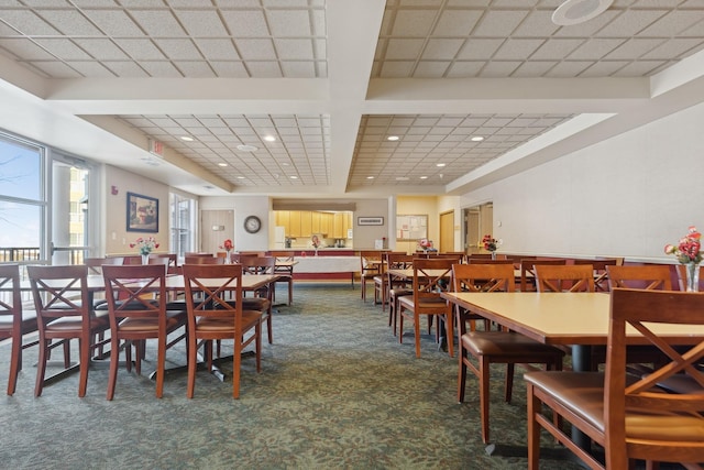 dining space featuring dark colored carpet