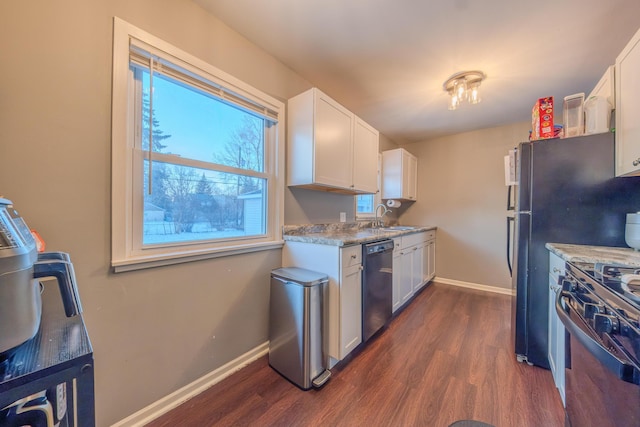 kitchen with stainless steel appliances, white cabinetry, and sink