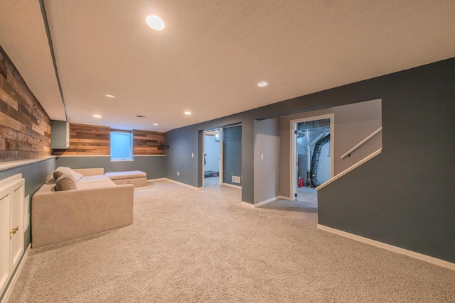 basement featuring light carpet and a textured ceiling