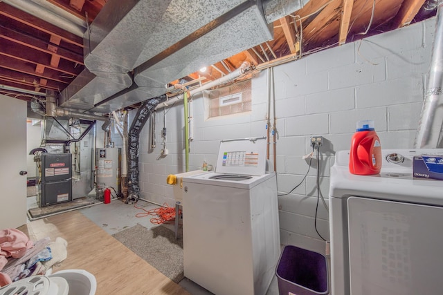 interior space with washing machine and dryer, heating unit, and gas water heater