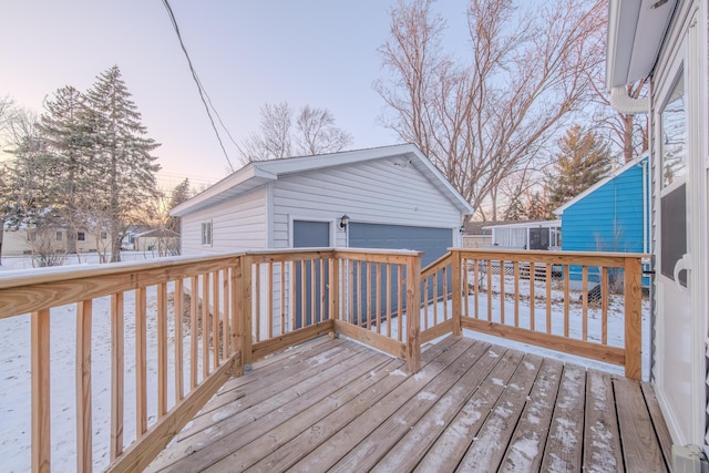 deck at dusk with a garage and an outdoor structure