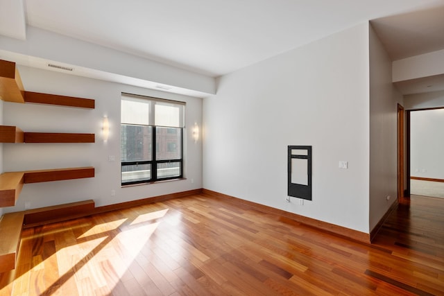 unfurnished living room with hardwood / wood-style flooring