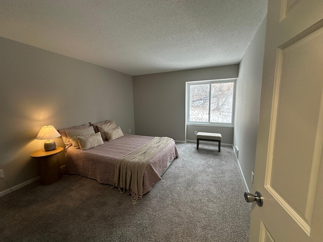 bedroom with a textured ceiling and carpet flooring