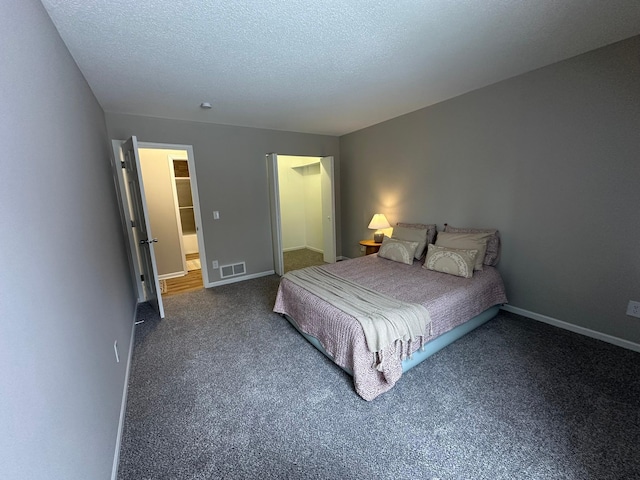 carpeted bedroom with a textured ceiling